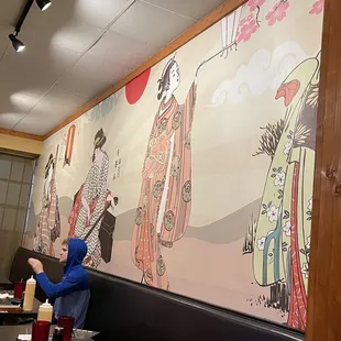 a woman sitting at a table in a restaurant