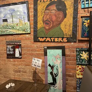 a brick wall with paintings on it