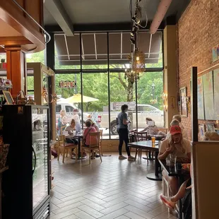 people sitting at tables in a restaurant