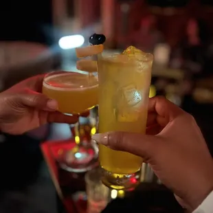 two people toasting drinks