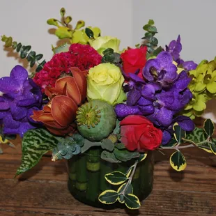 One of our usual boring flat and crowded arrangement of short stemmed blooms of garish color.