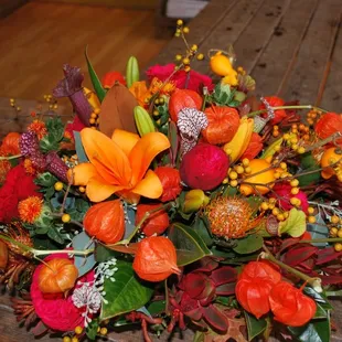 Rainforest can set the mood for your next get together. Here a Fall themed centerpiece for a food table creates a stunning look.