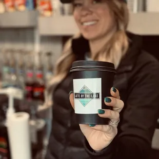 a woman holding a cup of coffee