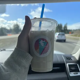 a hand holding a cup of coffee