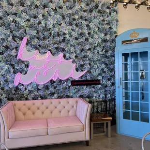 a pink couch and a blue door