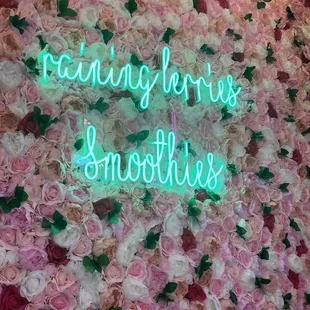 Cute neon &quot;Raining Berries Smoothies&quot; sign.