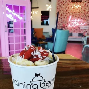 a cup of ice cream with strawberries