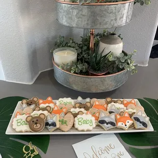 a tray of cookies and a sign that says welcome little ones