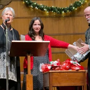 Drawing for prizes with Deb in the center and the owner of Rainy Day Books on the left.