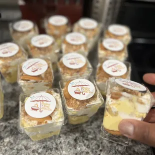 a person holding a small cup of food