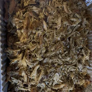 a tin foil container filled with shredded meat