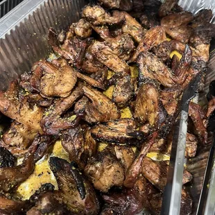 a tray of ribs and mushrooms