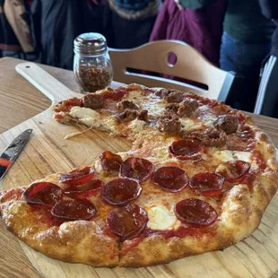 Pizza with beef pepperoni, behind sausage and ricotta