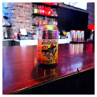 a can of beer on a bar