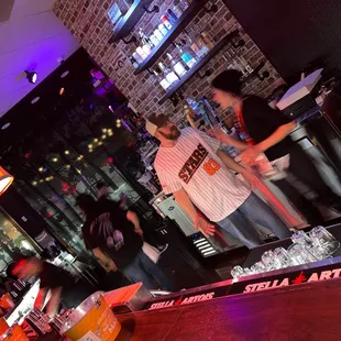 a bartender serving a drink at a bar