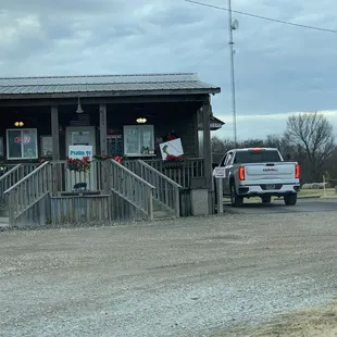 a pickup truck parked in front of a restaurant