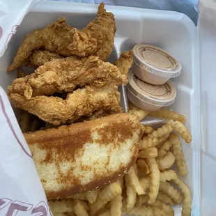 fried chicken and french fries in a styrofoam container