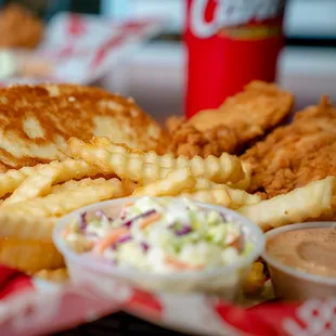 a plate of food with fries and coleslaw