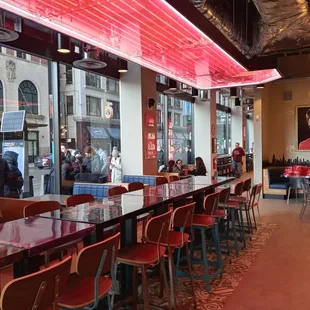 a restaurant with red neon lights