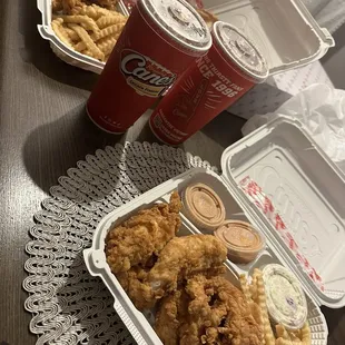 a tray of fried chicken and fries