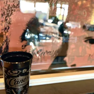 a cup of coffee on a window sill
