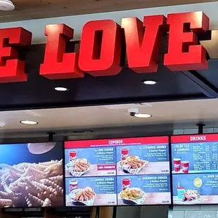 &quot;ONE LOVE&quot; Sign and the menu board, inside Raising Cane&apos;s Ceres.