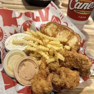The Box Combo - 4 fingers, crinkle cut fries, coleslaw, texas toast, one Cane&apos;s sauce (I also added a honey mustard to try) with a drink