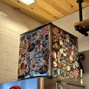 a refrigerator covered in stickers