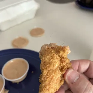 chicken tender with a hair in it .