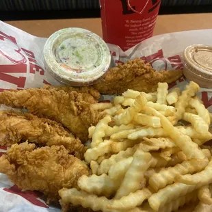 a basket of fried chicken and french fries