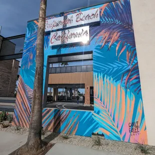 a colorful building with palm trees