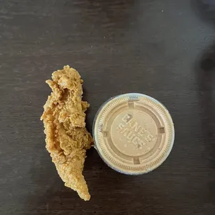 Chicken finger comparison to small sauce cup.