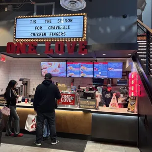people standing in front of the sign