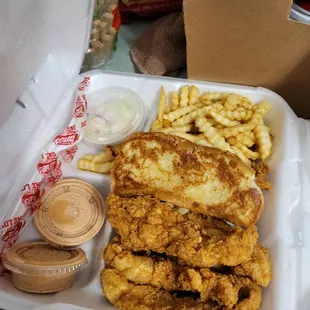 fried chicken and fries in a styrofoam container
