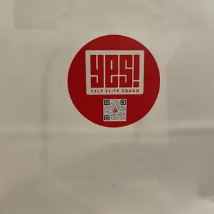 a white bag with a red sticker on it