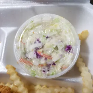 a container of coleslaw and fries