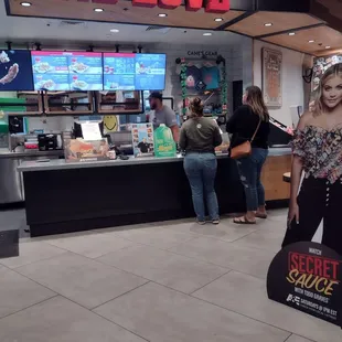 a woman standing in front of a one love restaurant