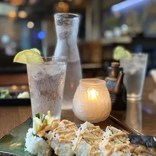 a plate of sushi and a glass of water