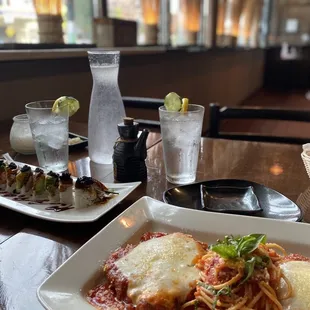 a plate of spaghetti and a glass of water