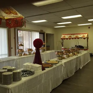 a long table with a variety of food items