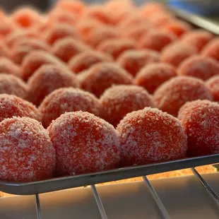 a tray of sugared doughnuts