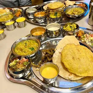 Thali way!  Mini buffet that comes to you of Indian curries/sauces around the rice and sides on individual round metal platters