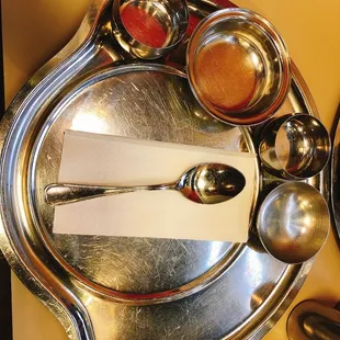 a silver plate with spoons and spoons