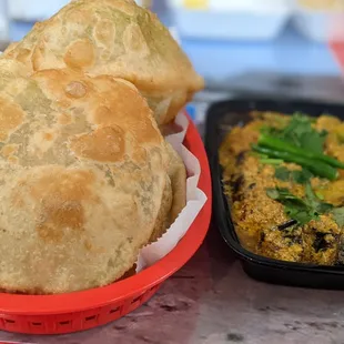 a basket of bread and a bowl of curry