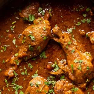 a close up of chicken curry in a pan