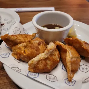 a plate of food with dipping sauce