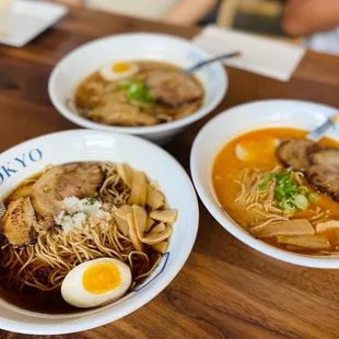 three bowls of ramen and a hard boiled egg
