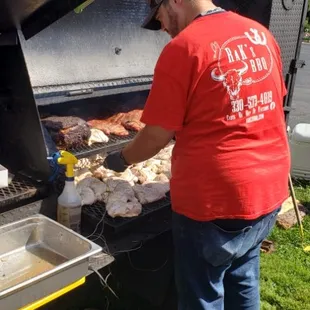 a man preparing food on a grill