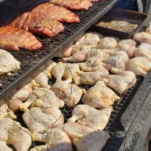 a man cooking meat on a grill