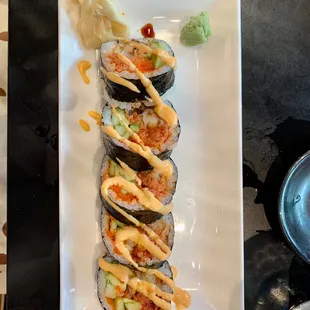 a plate of sushi with sauce on it